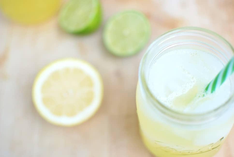 Natural electrolyte drink next to some lemons and limes