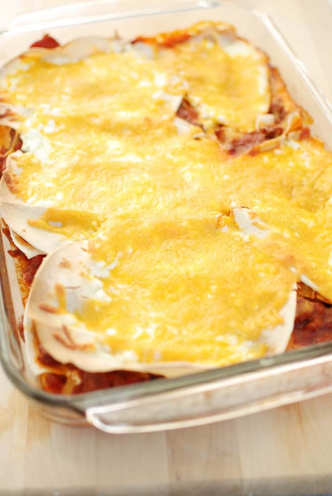 Texas lasagna is a southwestern style casserole recipe – flavors like chili powder and paprika are used to season the meat, corn tortillas take the place of lasagna noodles, and cheddar replaces mozzarella. This healthy version is under 500 calories per serving yet still tastes rich and indulgent!