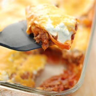 Texas lasagna is a southwestern style casserole recipe – flavors like chili powder and paprika are used to season the meat, corn tortillas take the place of lasagna noodles, and cheddar replaces mozzarella. This healthy version is under 500 calories per serving yet still tastes rich and indulgent!