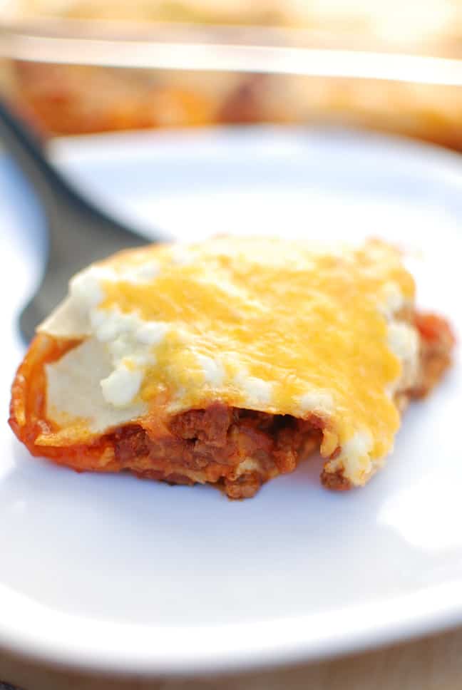 Texas lasagna is a southwestern style casserole recipe – flavors like chili powder and paprika are used to season the meat, corn tortillas take the place of lasagna noodles, and cheddar replaces mozzarella. This healthy version is under 500 calories per serving yet still tastes rich and indulgent!