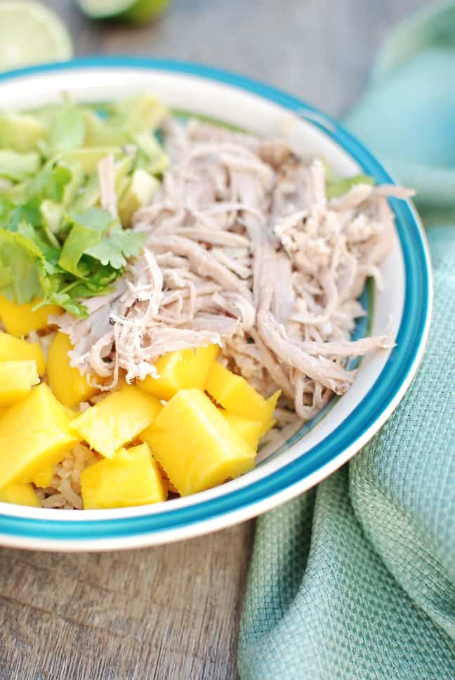 YUM! These pork burrito bowls with avocado and mango are so easy to make. Less than 10 ingredients to pick up at the store and less than 30 minutes of prep time! A great healthy dinner recipe. 