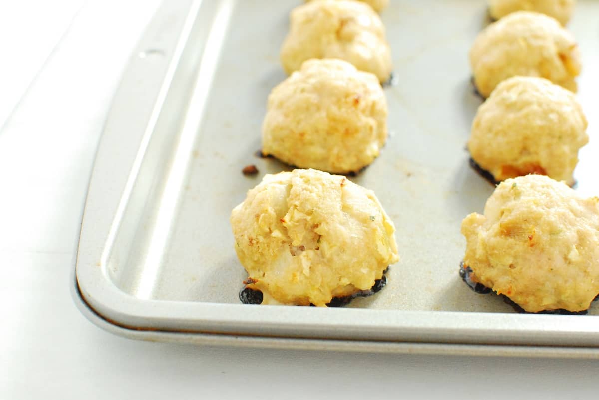 Cooked meatballs on a baking sheet.