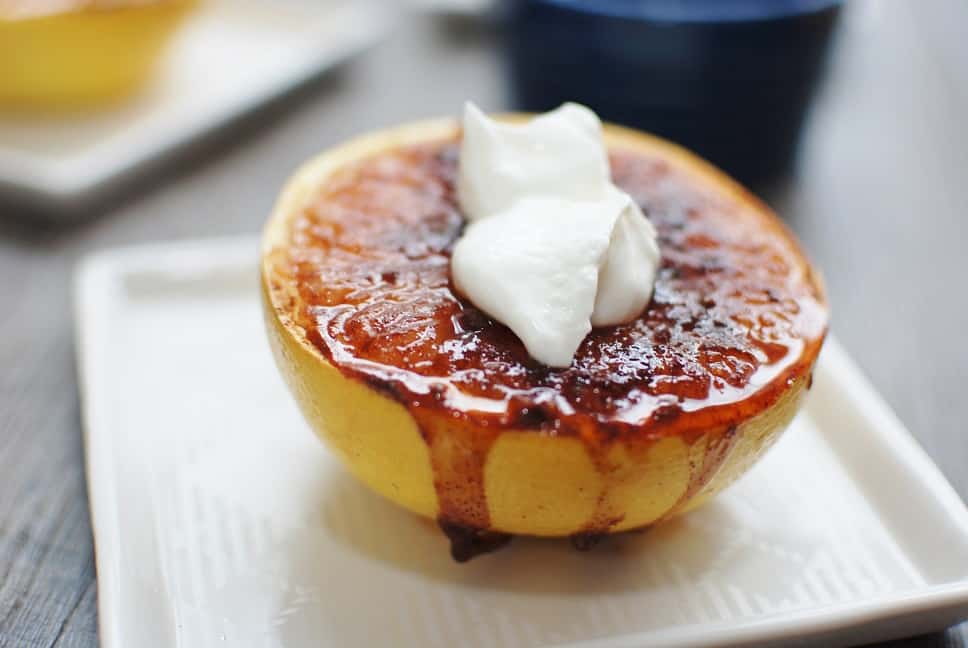 Broiled grapefruit half with a dollop of greek yogurt on top