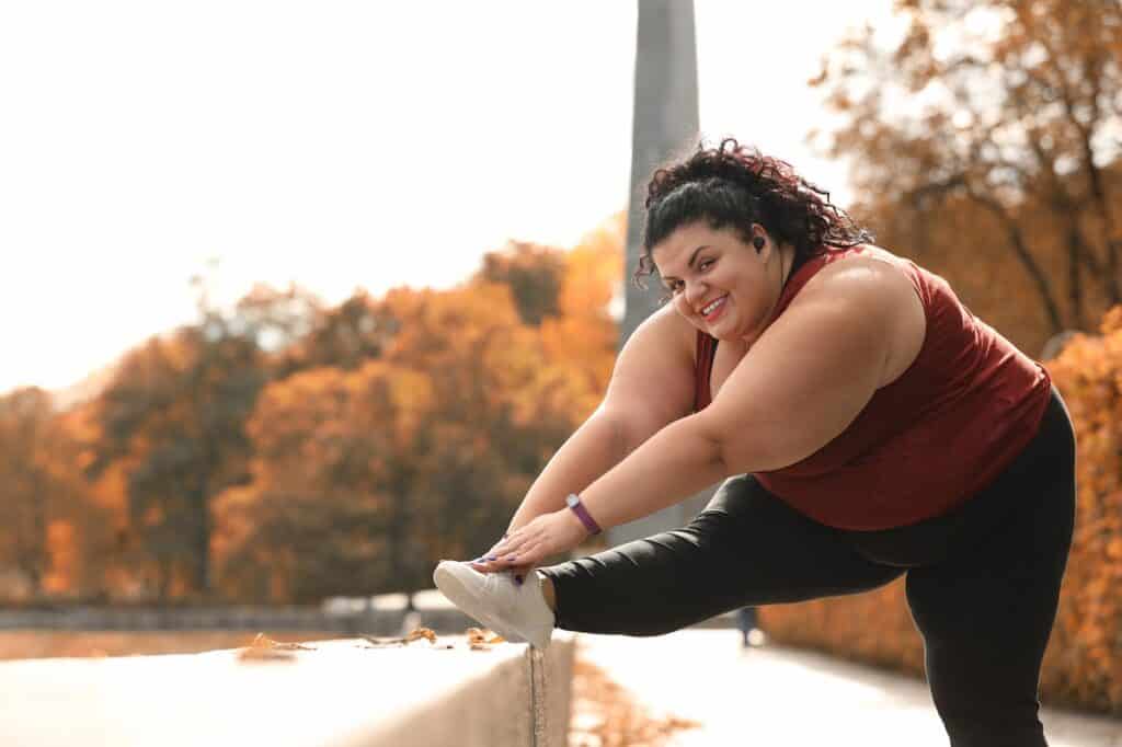 A woman stretching after an exercise session outside.