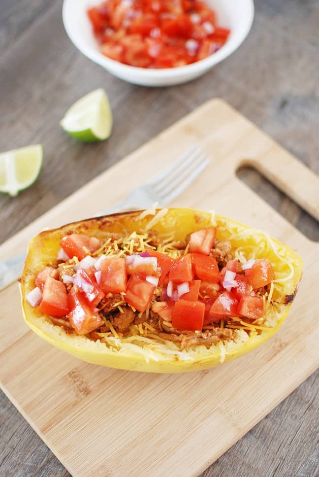 Spaghetti squash taco boats are tasty, nutritious, and perfect for a family dinner! Instead of using shells for your tacos, you simply add the meat and homemade salsa on top of roasted spaghetti squash. And at under 400 calories each, it’s a filling meal you can feel good about eating! Gluten free and dairy free options available.
