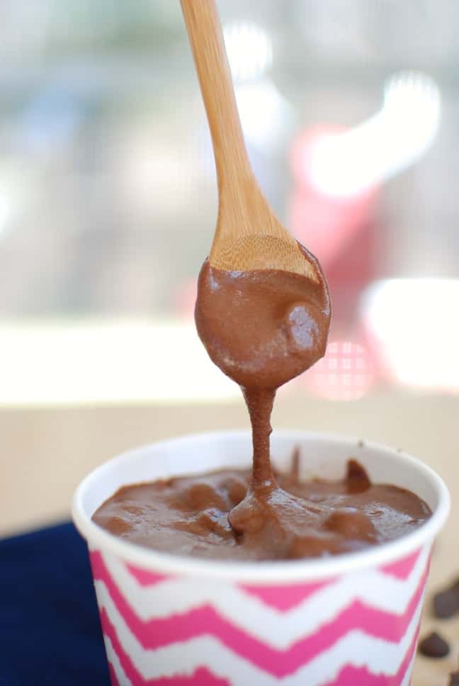 Healthy brownie batter dripping off of a spoon