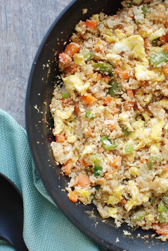 Cauliflower fried rice is a 30 minute meal that tastes like Chinese takeout – but in a healthier at home recipe! With less than 10 ingredients, you’ll have this low calorie, low carb dish. Enjoy a small portion for a side dish or a large portion for dinner! | Vegetarian | Dairy Free | Family Friendly