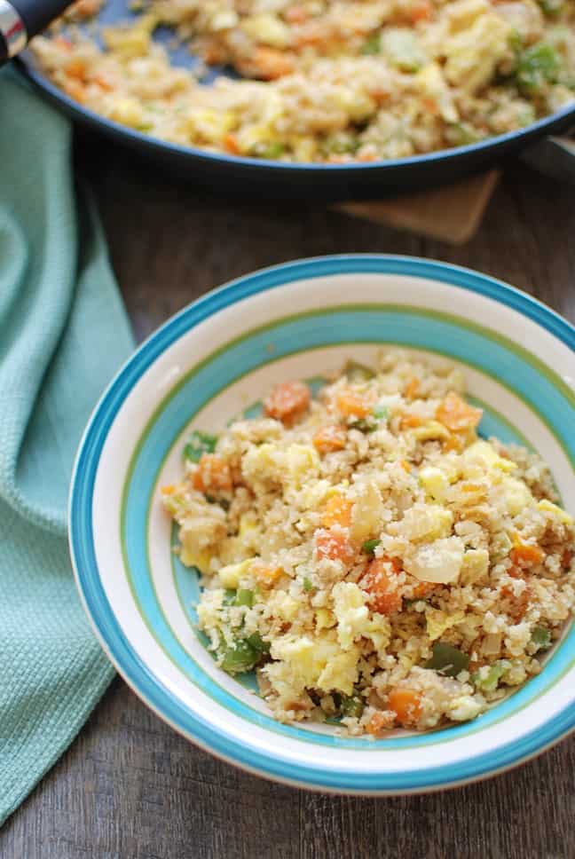 Cauliflower fried rice is a 30 minute meal that tastes like Chinese takeout – but in a healthier at home recipe! With less than 10 ingredients, you’ll have this low calorie, low carb dish. Enjoy a small portion for a side dish or a large portion for dinner! | Vegetarian | Dairy Free | Family Friendly