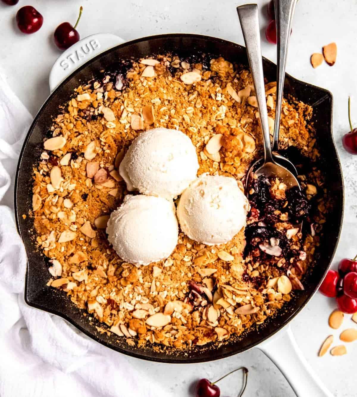 Fresh cherry crisp cooked in a cast iron skillet.
