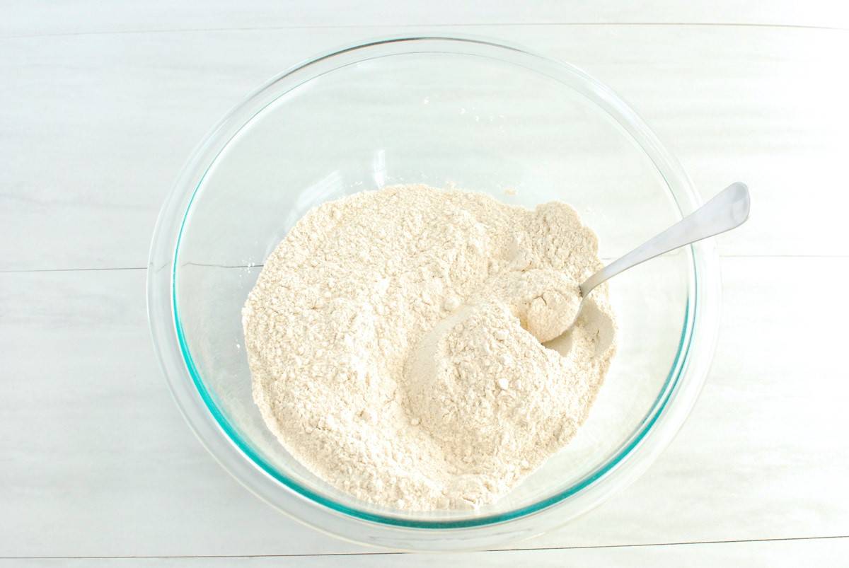 Flour, sugar, baking powder, and salt mixed together in a bowl.