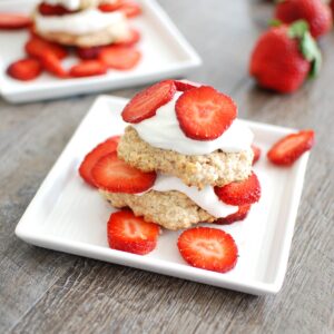 A healthy strawberry shortcake on a white plate.