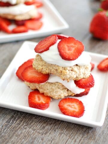 A healthy strawberry shortcake on a white plate.