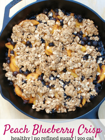 A cast iron skillet with peach blueberry crisp, with a text overlay with the name of the recipe.