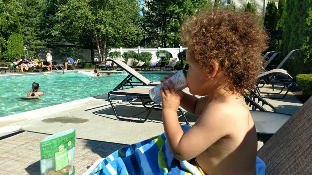 Child at a swimming pool in the summertime