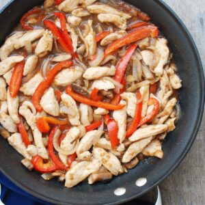 A pan full of chicken mushroom pepper stir fry.