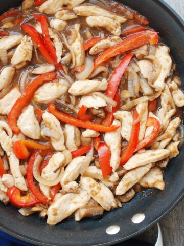 A pan full of chicken mushroom pepper stir fry.