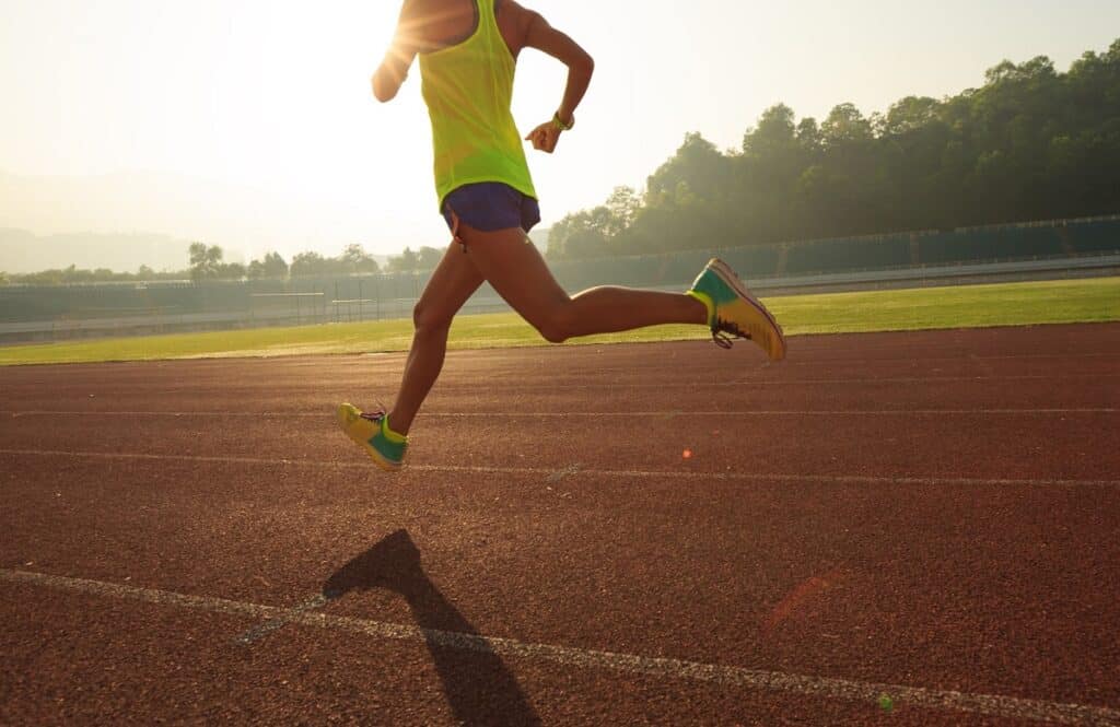 A woman running on a track.