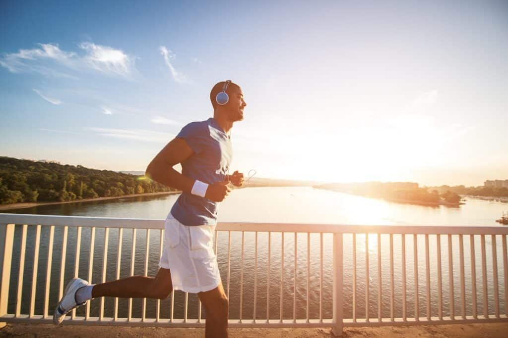 A man doing a run outside while listening to music.