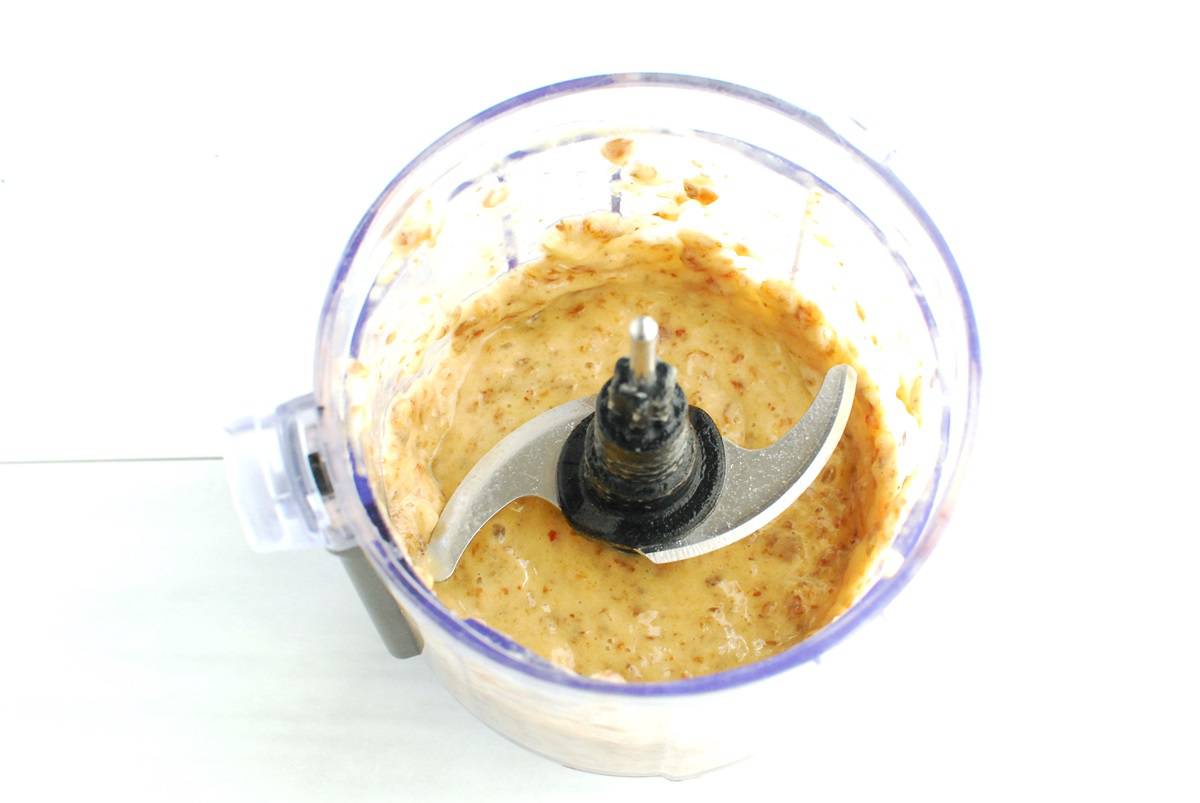 Banana and dates mixed together in a food processor bowl.