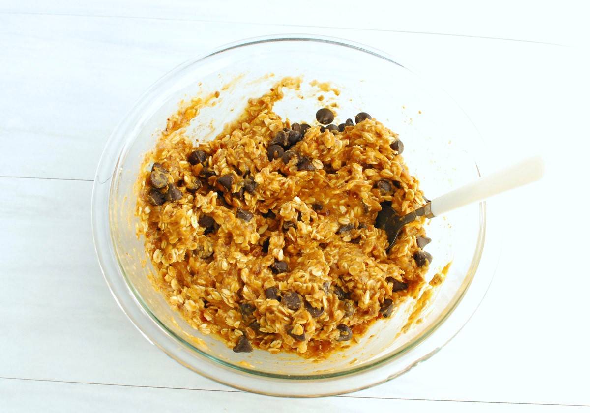 All of the pumpkin oatmeal ingredients combined in a glass mixing bowl.