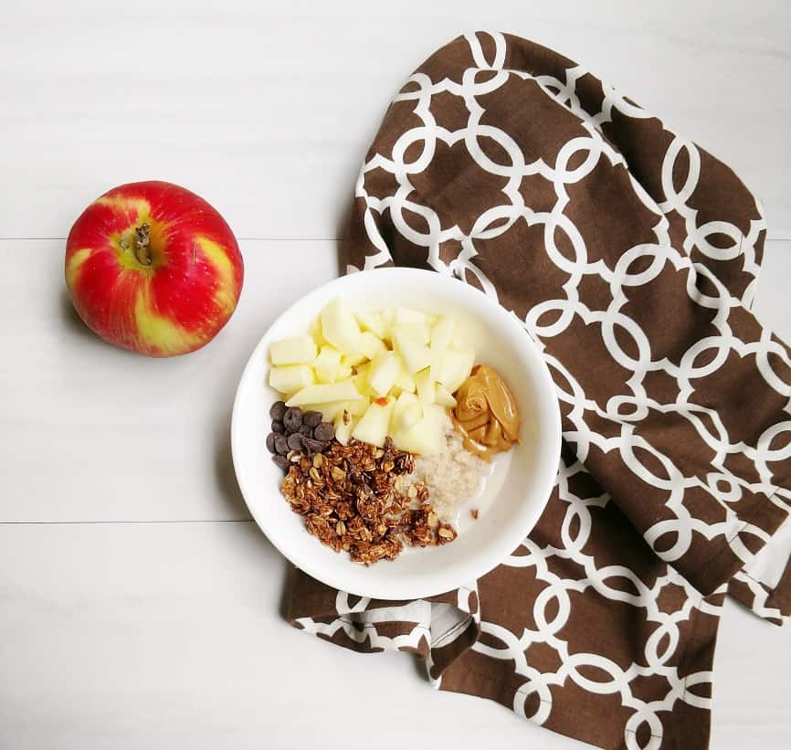 Delicious oatmeal with peanut butter, chocolate granola, and apples!