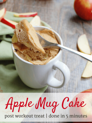 an apple mug cake in a white cup next to sliced apples