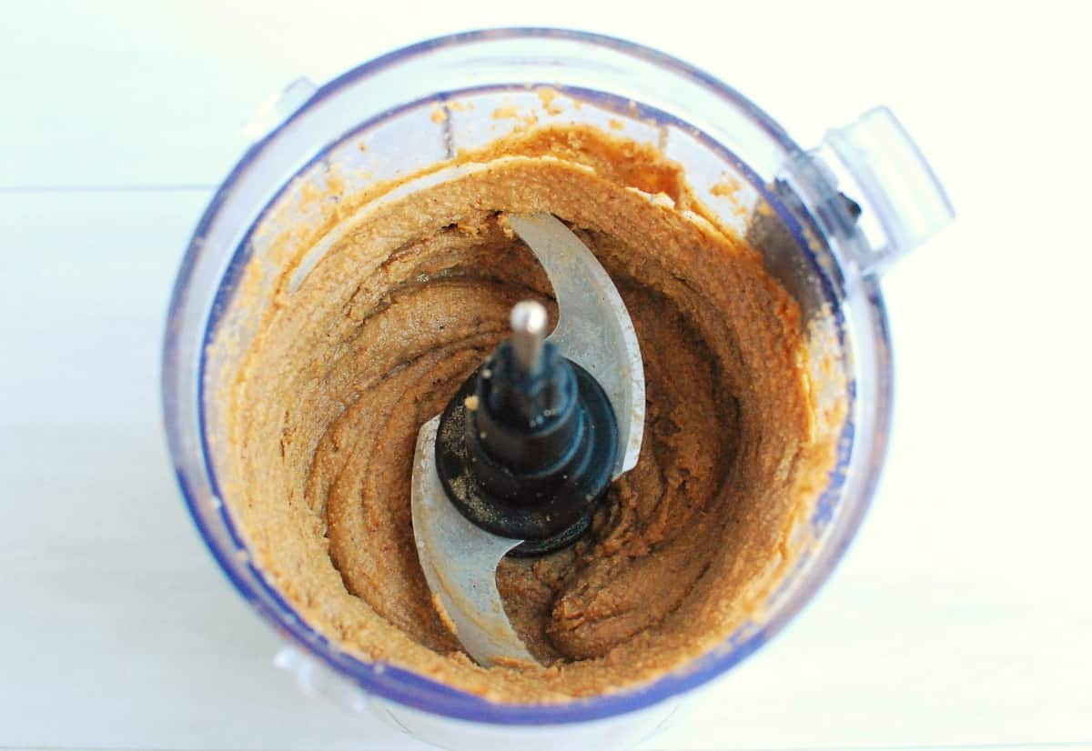Gingerbread almond cashew butter in a food processor bowl.