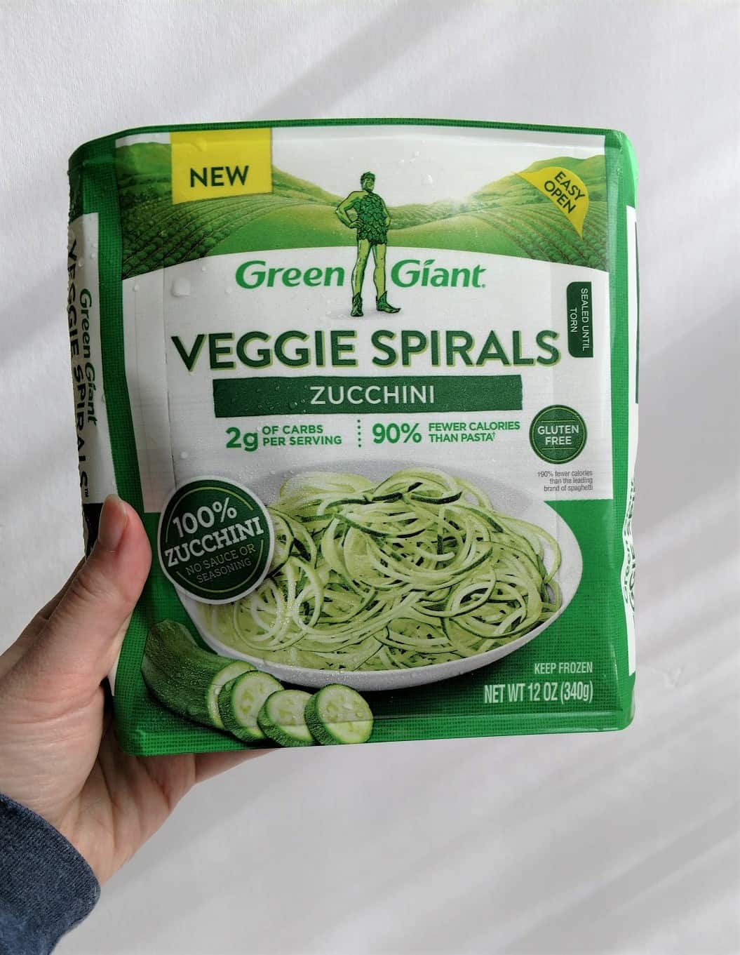 Hand holding a package of Green Giant Veggie Spirals zucchini noodles