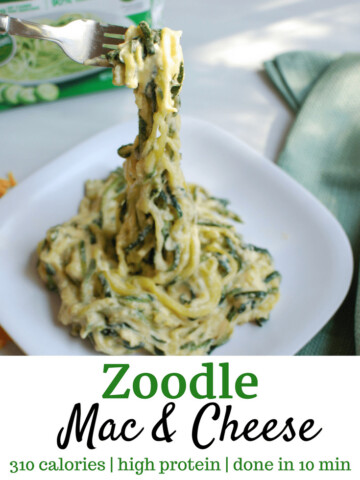 Fork lifting up zoodle macaroni and cheese from white plate
