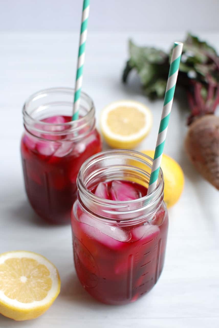 beet lemonade in two mason jars with striped straws