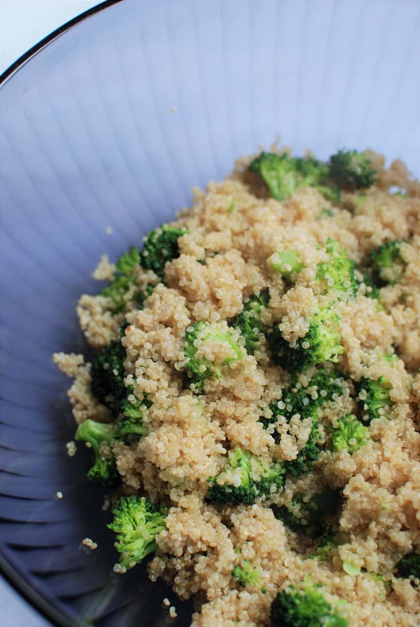 Purple bowl full of quinoa and broccoli