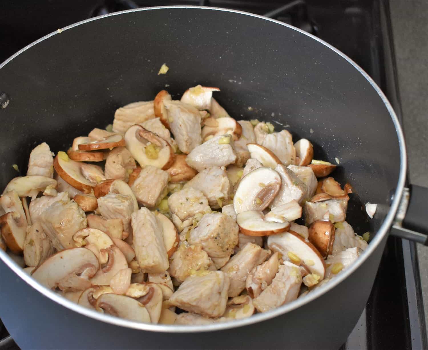 Pork, mushrooms, ginger and garlic in a large pot