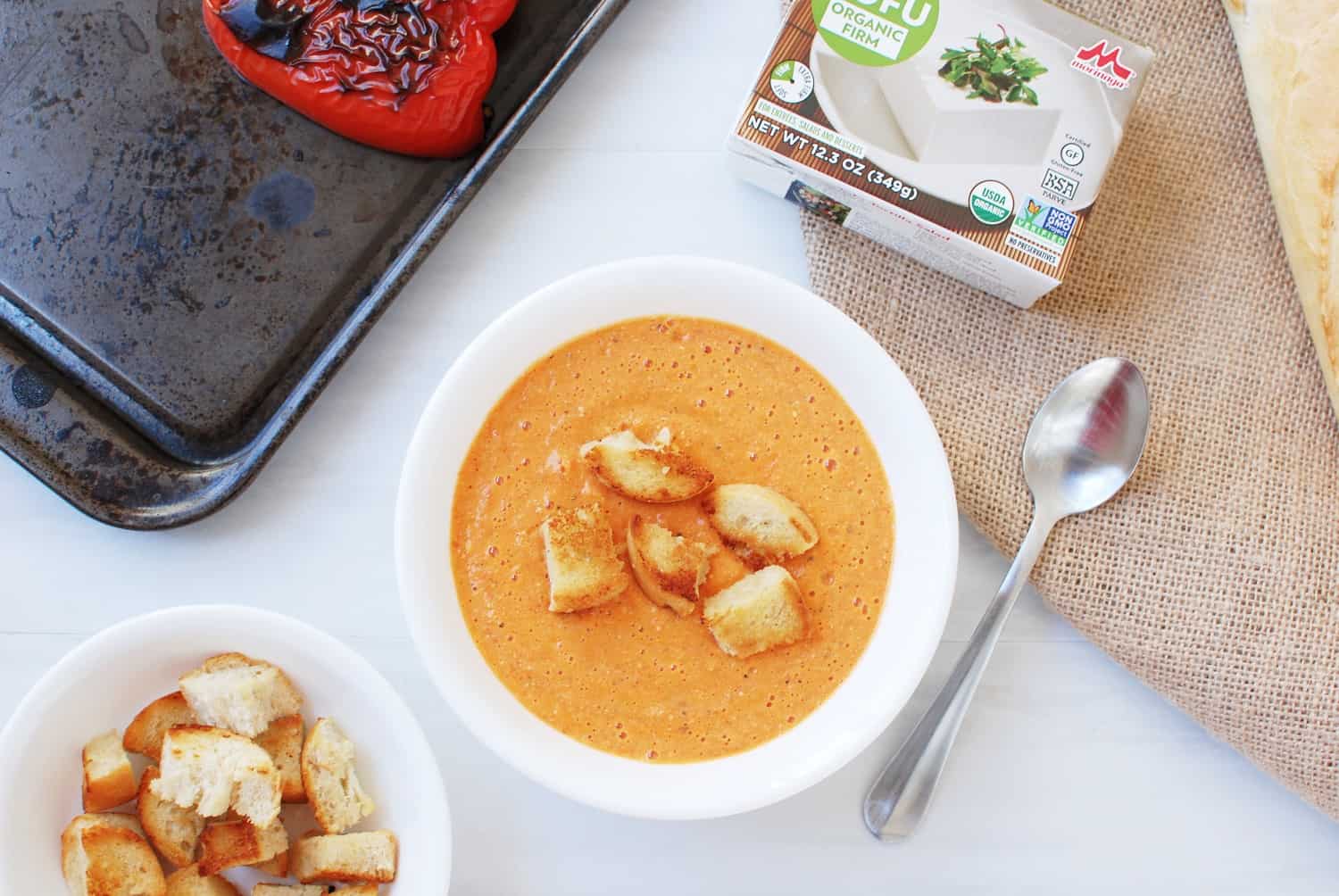 Bowl of Roasted Red Pepper and Gouda Soup topped with croutons