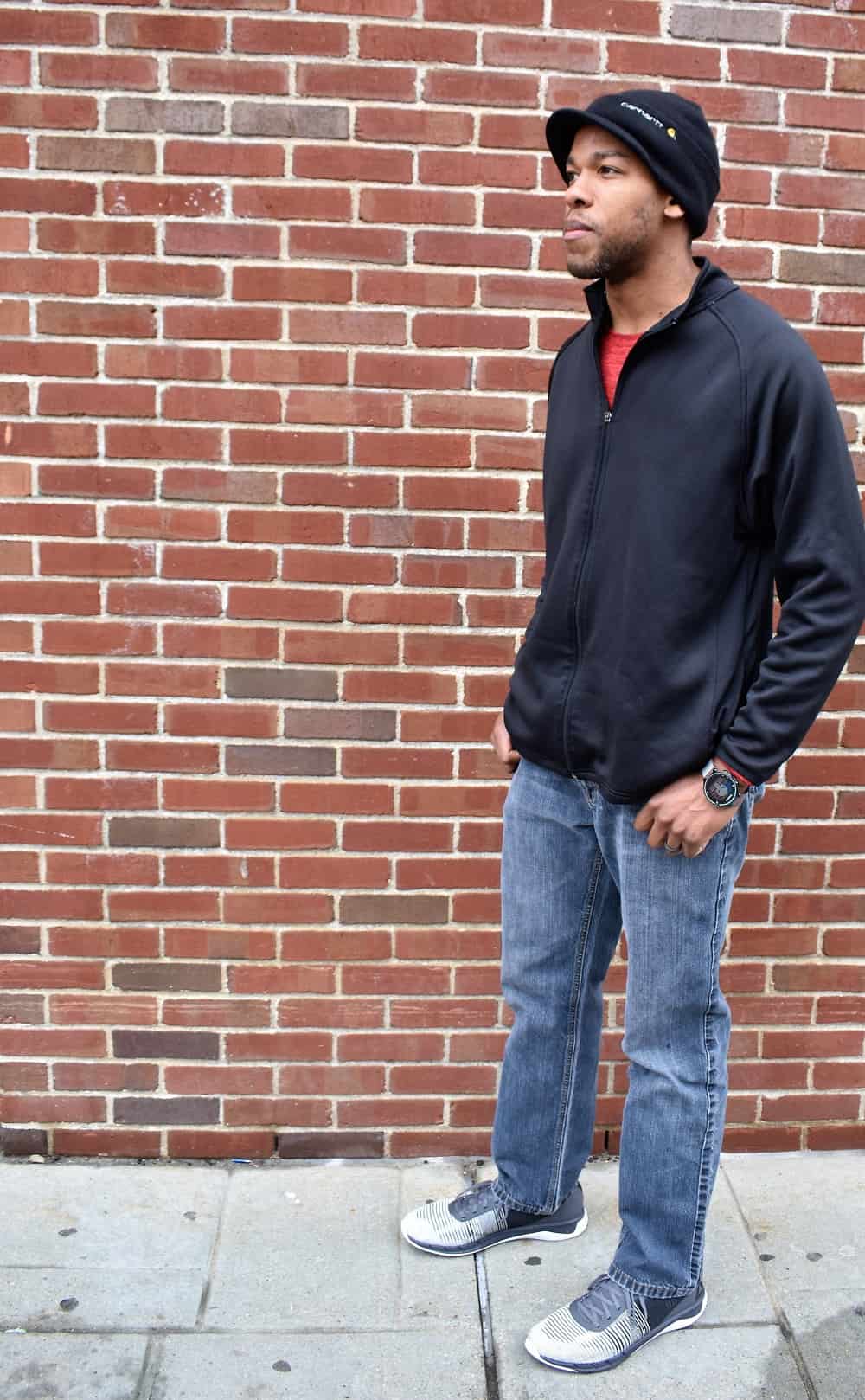 Man wearing a black shirt, jeans, and Reebok Fast Flexweave sneakers