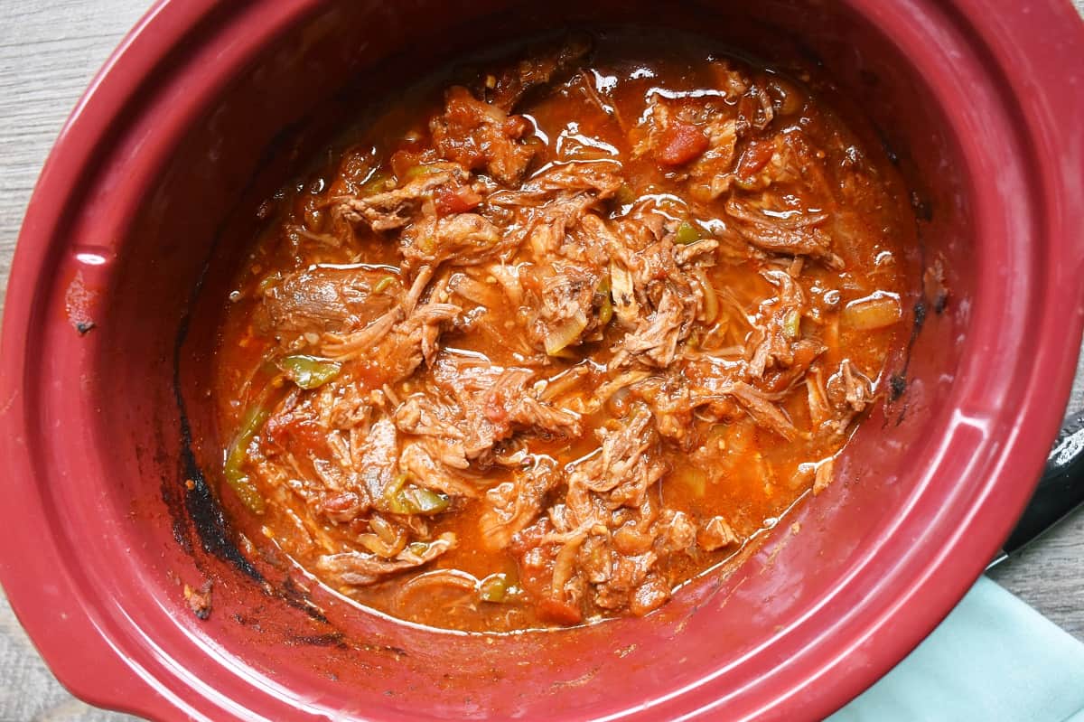 Slow cooker shredded beef still in the crockpot bowl.