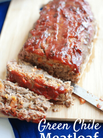 Green chile meatloaf on a cutting board with a text overlay