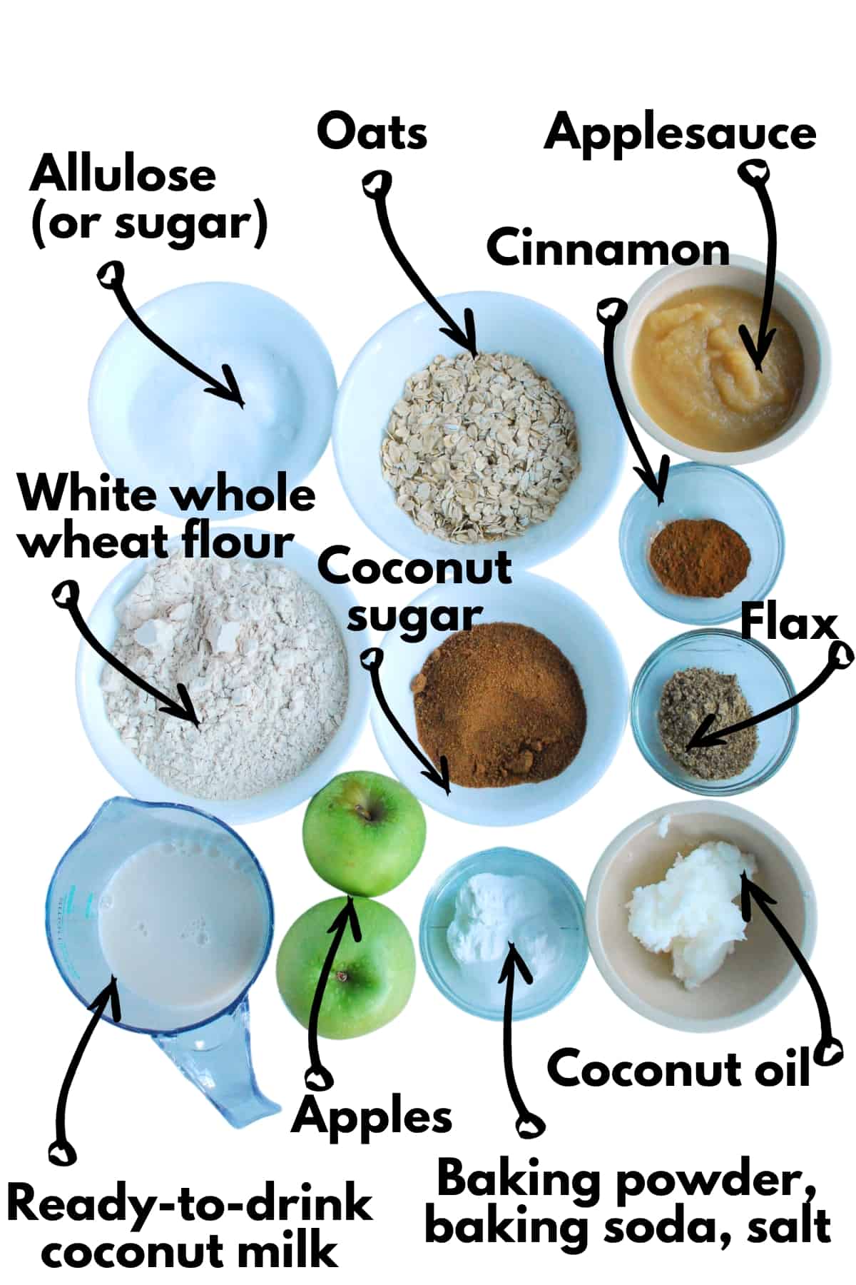 All of the ingredients to make muffins on a white background.