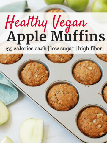 Vegan apple muffins in a muffin tin next to apples