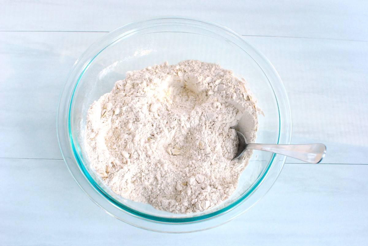 All the dry ingredients for the muffins combined in a glass mixing bowl.