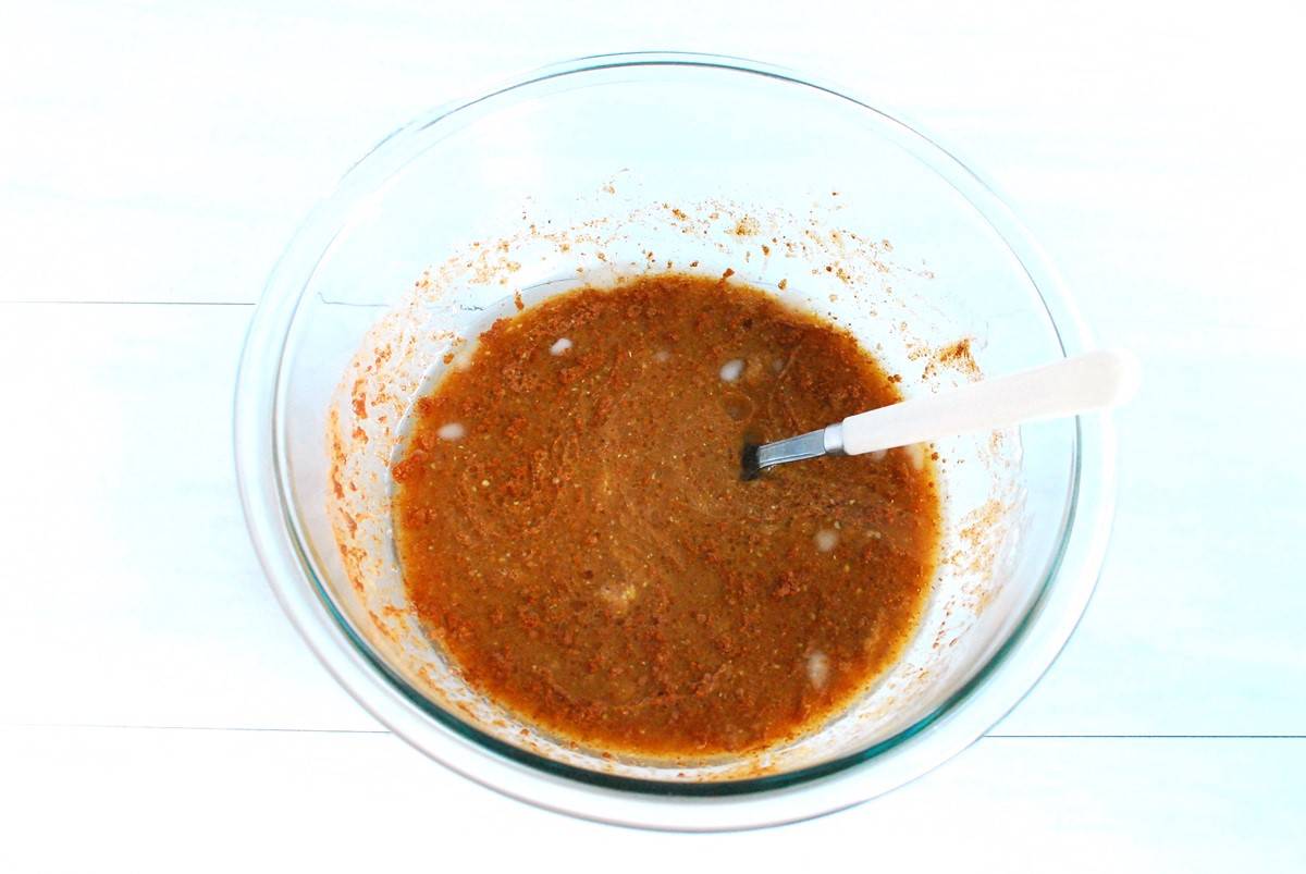 All the wet ingredients for the muffins combined in a glass mixing bowl.