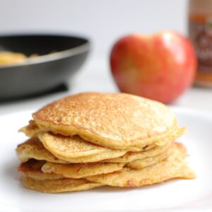 A stack of cottage cheese protein pancakes on a white plate.