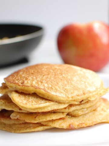 A stack of cottage cheese protein pancakes on a white plate.