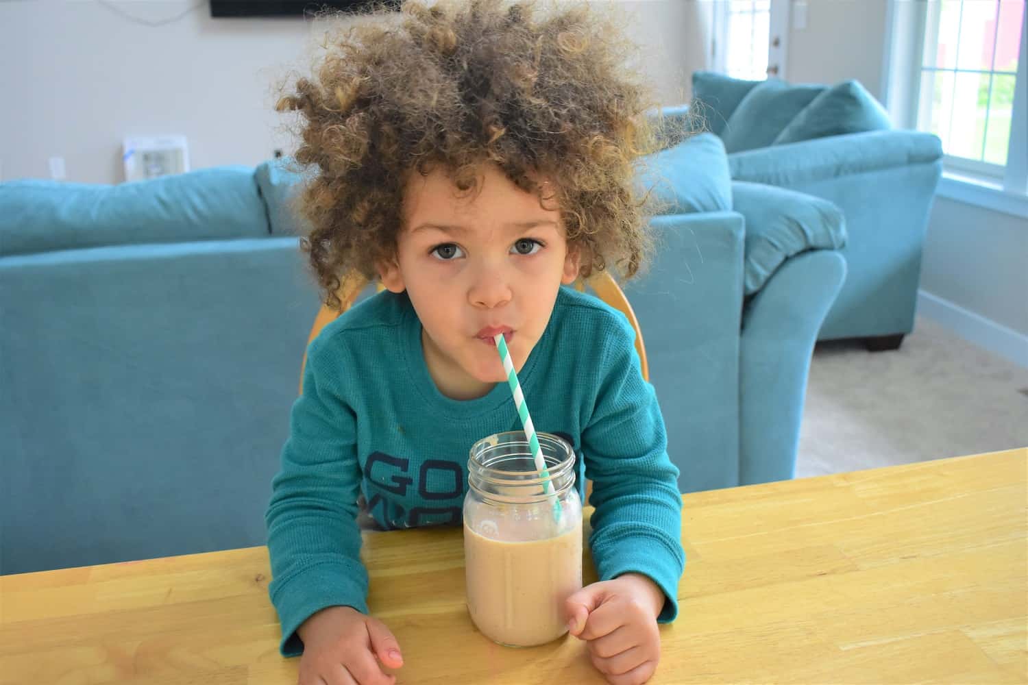 Child drinking a granola smoothie