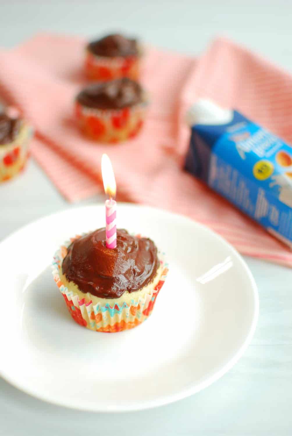 Vegan vanilla cupcake with a birthday candle