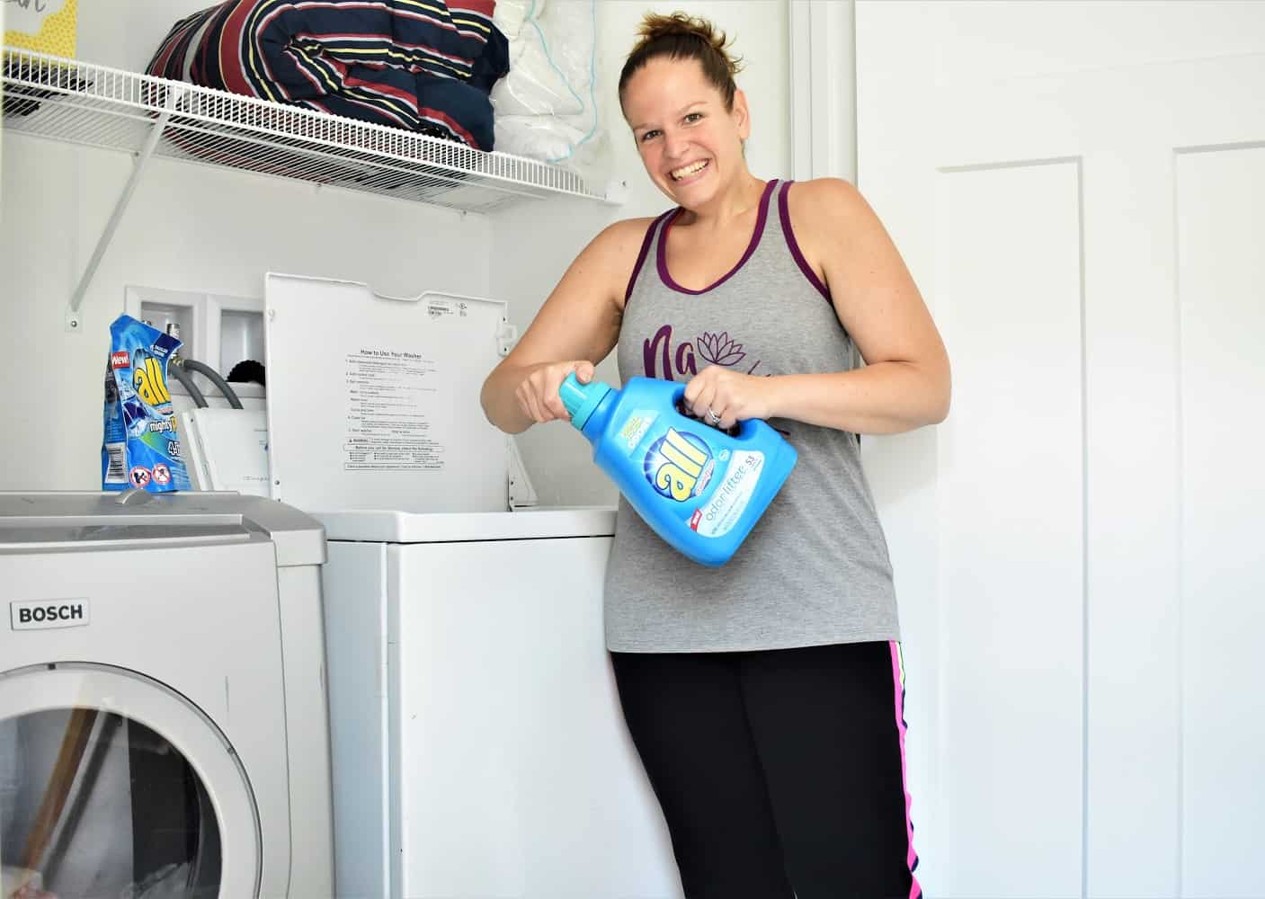 Woman Holding All Detergent to wash workout clothes