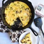Cheeseburger frittata on a plate and in a cast iron skillet