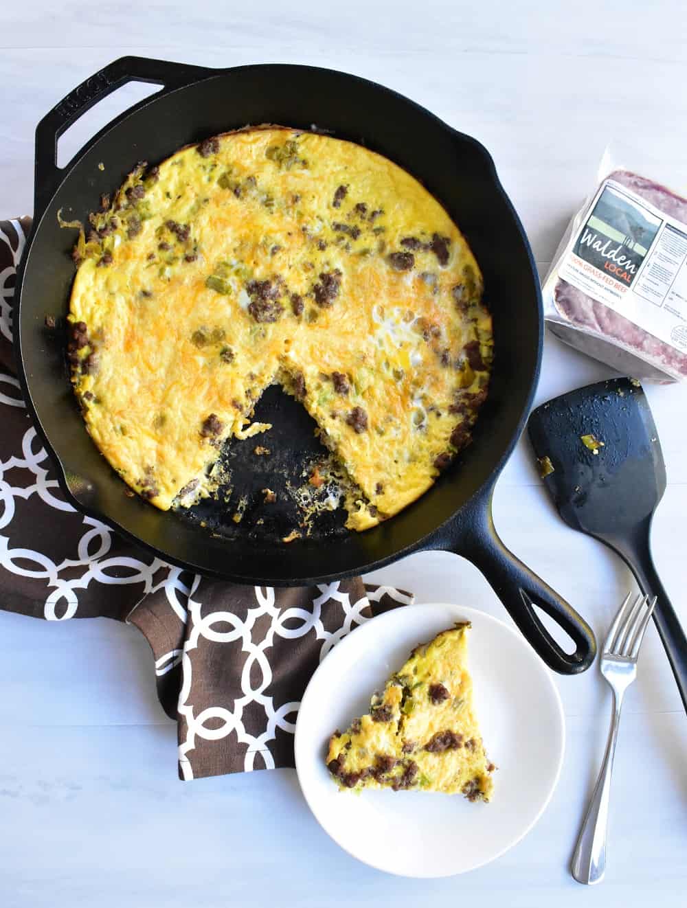 Cheeseburger frittata on a plate and in a cast iron skillet