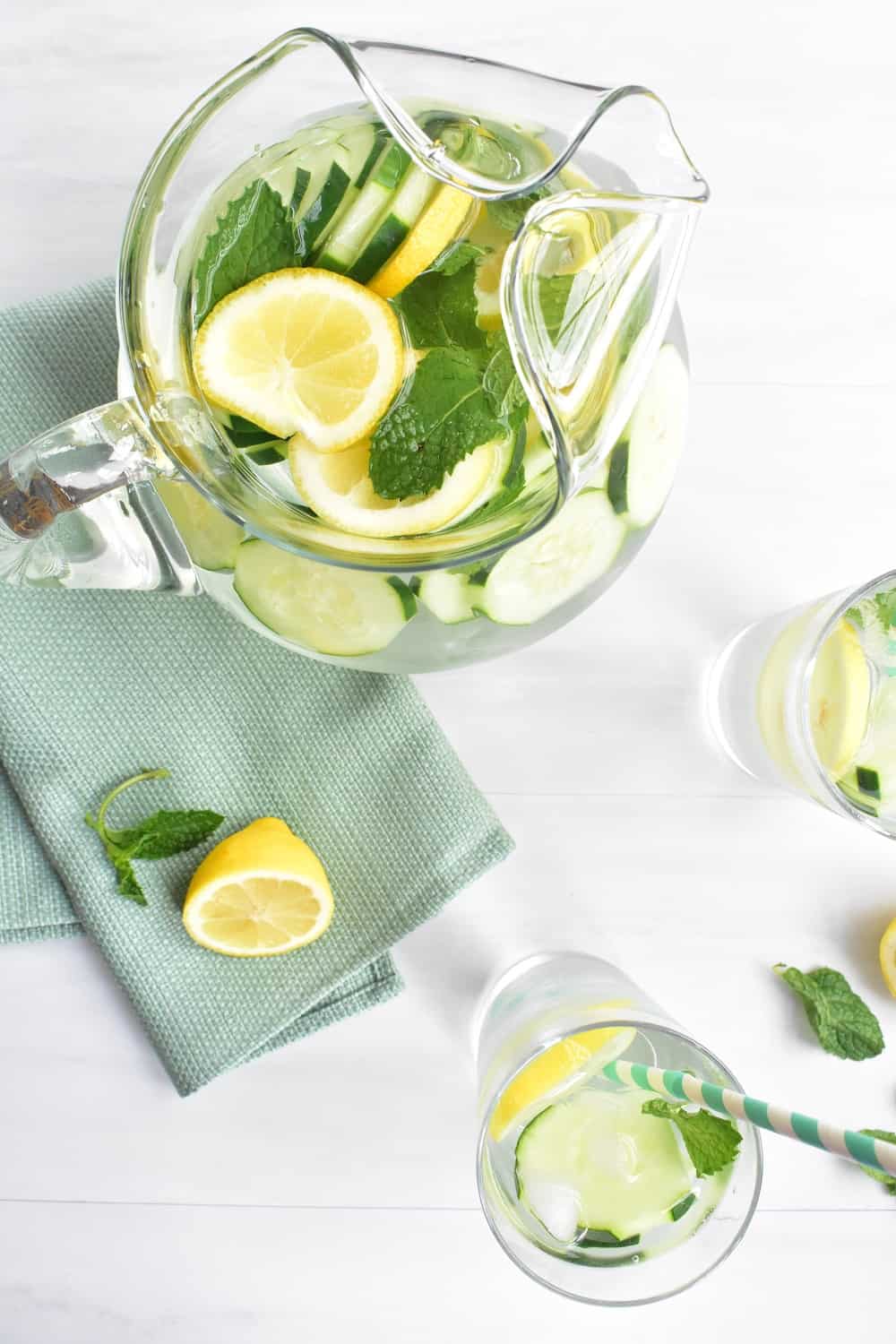 Pitcher and two glasses filled with lemon mint cucumber water