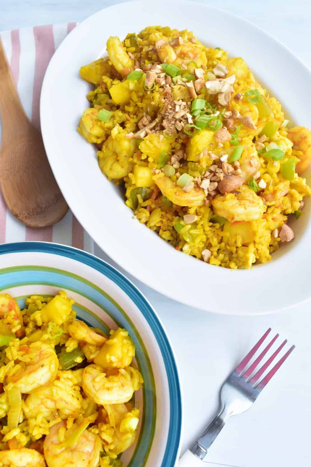 A large bowl and small bowl filled with pineapple fried rice.