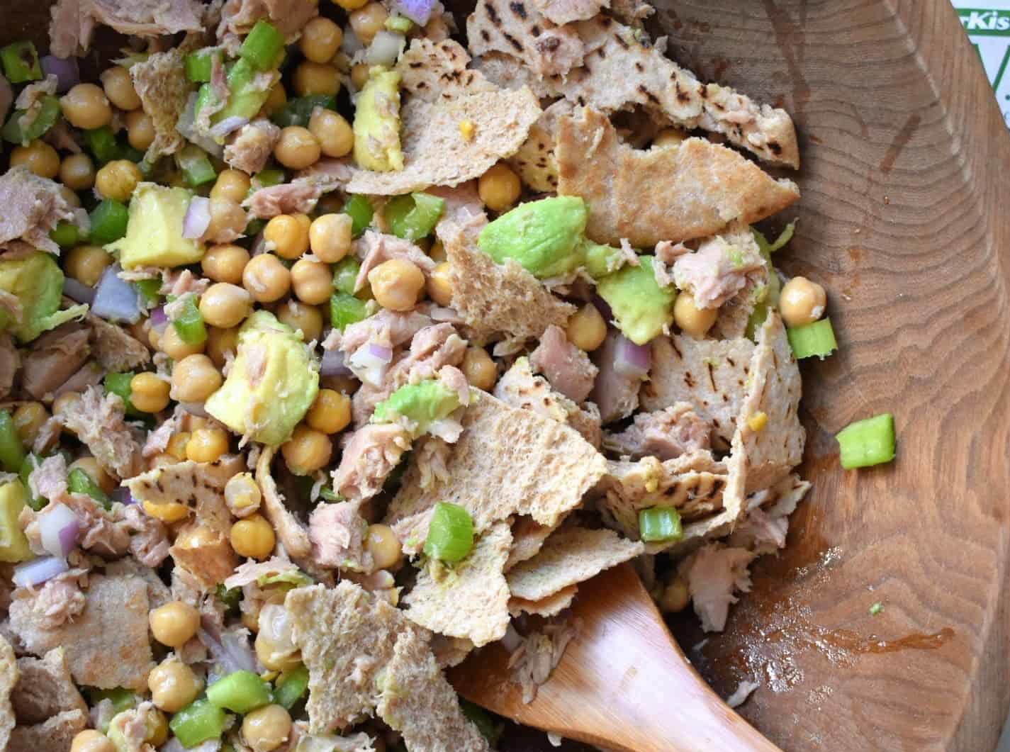 Chickpea tuna salad in a bowl with a wooden spoon